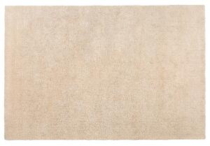 Nowoczesny dywan poliester beżowy gładki wykonany ręcznie 140 x 200 cm Demre Beliani