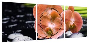 Obraz - Pomarańczowa orchidea z liśćmi palmy (z zegarem) (90x30 cm)