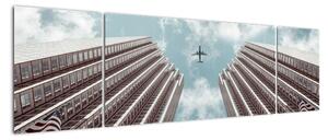 Obraz samolotu między budynkami (170x50 cm)