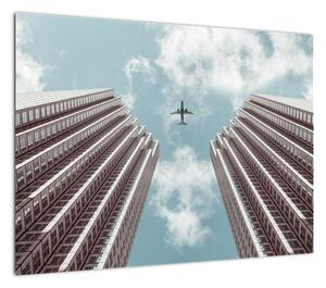 Obraz samolotu między budynkami (70x50 cm)