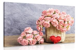 Obraz bukiet z różowych goździków w koszu