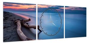 Obraz plaży o zachodzie słońca (z zegarem) (90x30 cm)