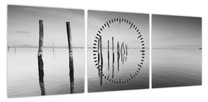 Obraz czarno - białej powierzchni wody (z zegarem) (90x30 cm)