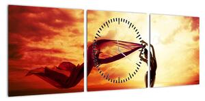 Obraz - Sylwetka kobiety o zachodzie słońca (z zegarem) (90x30 cm)