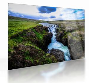 Obraz na szkle wodospadu między skałami (70x50 cm)