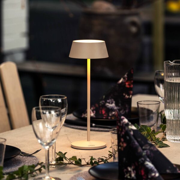 Konstsmide Lampa stołowa LED z akumulatorem Menton, kolor piaskowy, wysokość 27 cm, IP54, możliwość ściemniania, kremowy / amber, salon / jadalnia, aluminium, nowoczesny
