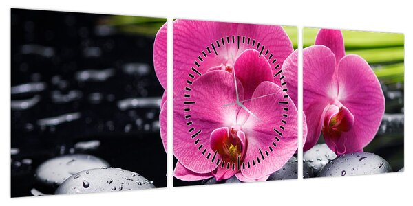 Obraz - Różowe orchidee z liściem palmy (z zegarem) (90x30 cm)