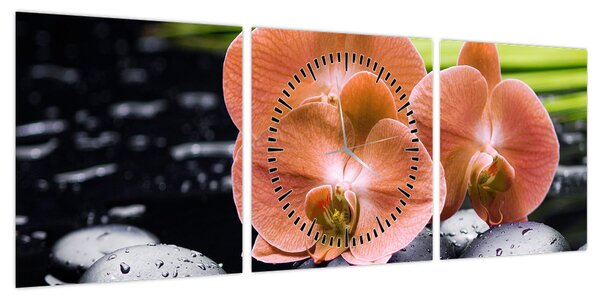Obraz - Pomarańczowa orchidea z liśćmi palmy (z zegarem) (90x30 cm)