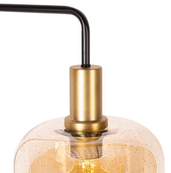 Designerska lampa podłogowa czarna z mosiądzem i bursztynowym szkłem - Zuzanna
