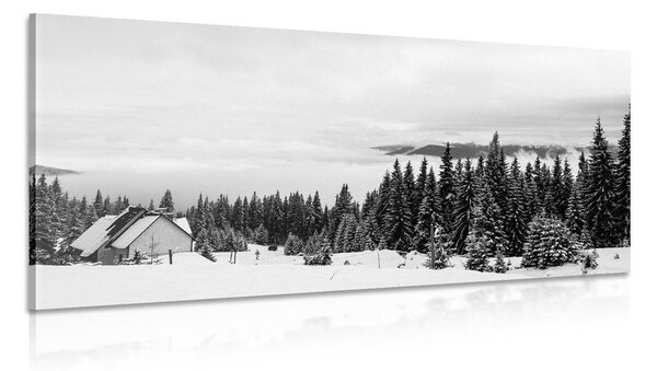 Obraz drewniany domek w śnieżnej przyrodzie w wersji czarno-białej