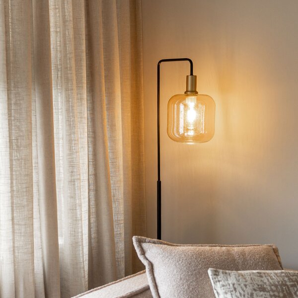 Designerska lampa podłogowa czarna z mosiądzem i bursztynowym szkłem - Zuzanna
