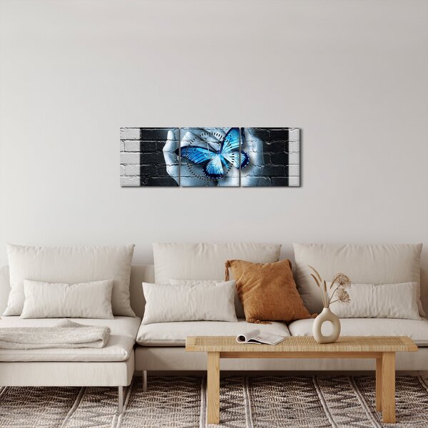 Obraz niebieskiego motyla na ścianie (z zegarem) (90x30 cm)