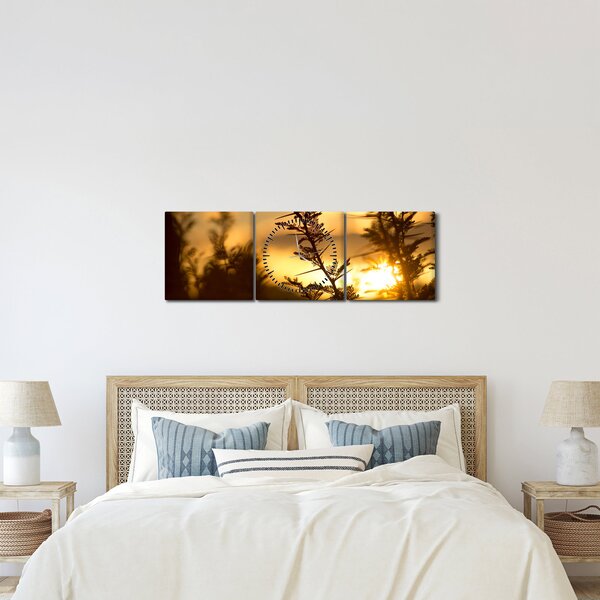 Obraz - słońce zachodzące za drzewami (z zegarem) (90x30 cm)