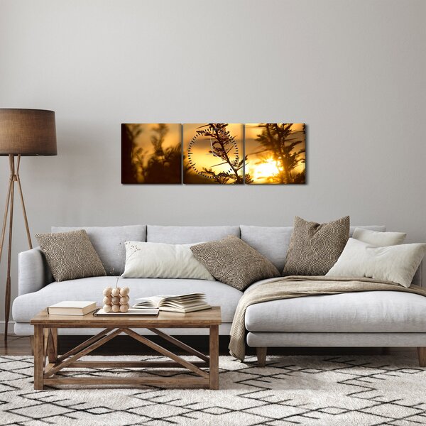 Obraz - słońce zachodzące za drzewami (z zegarem) (90x30 cm)