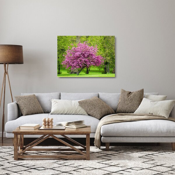 Obraz na szkle - kwitnące drzewo na łące (70x50 cm)