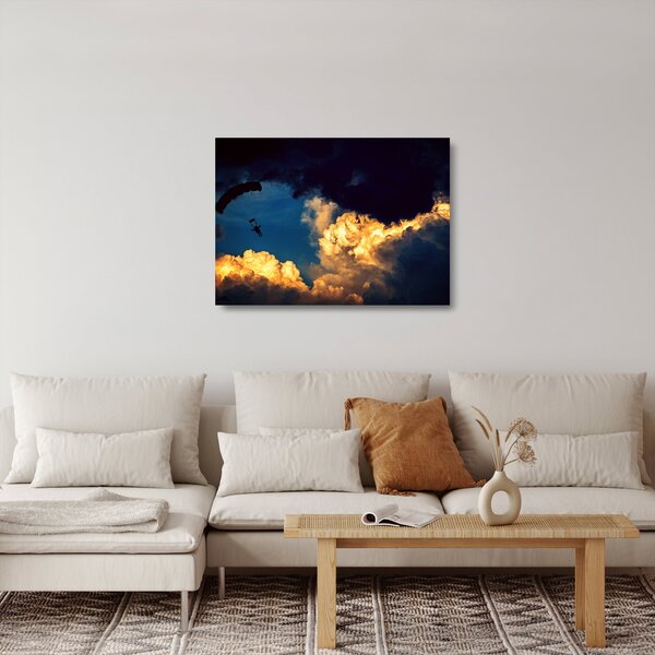 Obraz na szkle skoczka spadochronowego w chmurach (70x50 cm)
