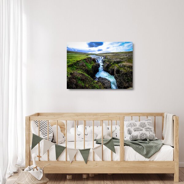 Obraz na szkle wodospadu między skałami (70x50 cm)