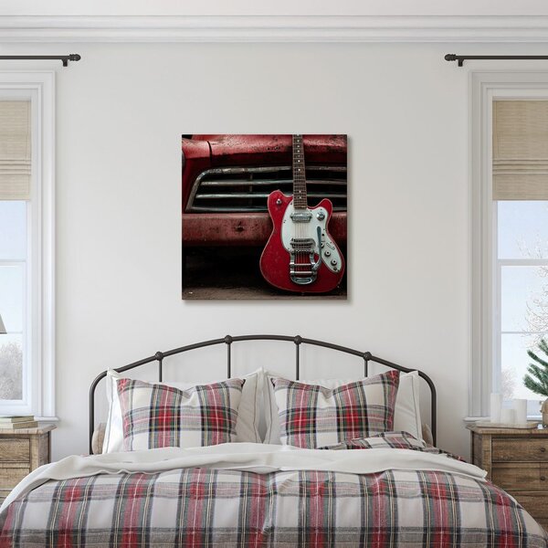Obraz czerwona gitara przed samochodem